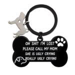 Black stainless steel dog keychain in the shape of a bone with a phrase engraved on it. Includes an additional natural stainless steel dog keychain on the keyring.